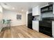 Stylish basement kitchen with white cabinets and black appliances at 1875 Jay St, Lakewood, CO 80214