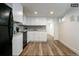 Efficient basement kitchen with white cabinets and black appliances at 1875 Jay St, Lakewood, CO 80214