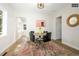 Charming dining area with hardwood floors and a round table at 1875 Jay St, Lakewood, CO 80214