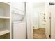Bright laundry room with washer, dryer, and shelving at 1875 Jay St, Lakewood, CO 80214