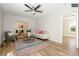 Bright living room with hardwood floors and ceiling fan at 1875 Jay St, Lakewood, CO 80214