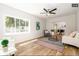 Bright living room with hardwood floors and ceiling fan at 1875 Jay St, Lakewood, CO 80214