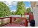 Backyard featuring a wooden deck, green grass, privacy fence, and mature trees at 16304 10Th St, Mead, CO 80542