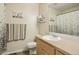 Cozy bathroom with framed mirror, patterned shower curtain, and decorative wall art at 16304 10Th St, Mead, CO 80542