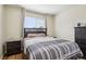 Comfortable bedroom with a bed, nightstand, dresser, and window with natural light at 16304 10Th St, Mead, CO 80542