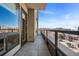 This condo boasts a large balcony with glass railings and plenty of room for outdoor seating with city views at 20 Wilcox St # 403, Castle Rock, CO 80104