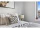 Close up of decorative pillows on bed and a view to exterior through the bedroom window at 20 Wilcox St # 403, Castle Rock, CO 80104