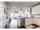 Open concept kitchen with island, stainless steel appliances, and white shaker cabinets at 20 Wilcox St # 403, Castle Rock, CO 80104