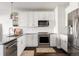 Modern kitchen featuring white cabinetry, stainless steel appliances, and subway tile backsplash at 20 Wilcox St # 403, Castle Rock, CO 80104