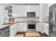 Well-lit kitchen with stainless steel appliances, white cabinets and subway tile, showcasing modern design at 20 Wilcox St # 403, Castle Rock, CO 80104