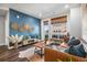 Cozy living room featuring a blue accent wall, leather couch, wooden coffee table, and a large window at 20 Wilcox St # 403, Castle Rock, CO 80104