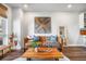 Stylish living room with hardwood floors, decorative wall art, leather sofa and open to the kitchen at 20 Wilcox St # 403, Castle Rock, CO 80104