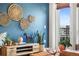 Living room showcasing blue wall with decor, wood accents, plants, and a view of the exterior at 20 Wilcox St # 403, Castle Rock, CO 80104