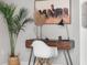 Close up of office desk, chair, decor, natural light, and a horse painting at 20 Wilcox St # 403, Castle Rock, CO 80104