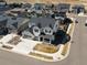 Expansive aerial view of a white two-story home, landscaped front yard, and located in a neighborhood at 904 Sundown Way, Erie, CO 80516