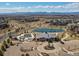 Aerial community view showcasing a pool, clubhouse, pond, and mountain views at 904 Sundown Way, Erie, CO 80516