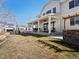 Wide view of the backyard and covered patio with ceiling fans and outdoor furniture at 904 Sundown Way, Erie, CO 80516