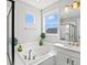 Bright bathroom showcasing a soaking tub, dual windows, and sleek, modern fixtures for a spa-like experience at 904 Sundown Way, Erie, CO 80516