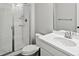 A clean bathroom featuring a glass-enclosed shower and a sleek white vanity with modern fixtures at 904 Sundown Way, Erie, CO 80516