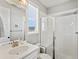 Bright bathroom showcasing a glass shower and a modern vanity with ample counter space at 904 Sundown Way, Erie, CO 80516