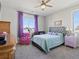 Inviting bedroom with a ceiling fan, large window, and charming decor for a cozy atmosphere at 904 Sundown Way, Erie, CO 80516