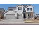 Inviting two-story home with a three-car garage, modern front door, and manicured lawn, ideal for families at 904 Sundown Way, Erie, CO 80516