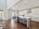 Bright kitchen featuring a large center island, stainless steel appliances, and hardwood floors at 904 Sundown Way, Erie, CO 80516