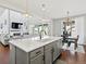 Open concept kitchen with island, dining area, and access to living room at 904 Sundown Way, Erie, CO 80516
