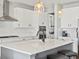 Close up of a kitchen with a center island with a sink, and a gas range stove at 904 Sundown Way, Erie, CO 80516