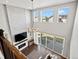 Bright living room with a floor-to-ceiling stone fireplace, high ceilings, large windows, and an open design at 904 Sundown Way, Erie, CO 80516