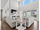 Modern living room with a large white brick fireplace and vaulted ceilings at 904 Sundown Way, Erie, CO 80516