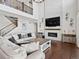 Living room showcasing a large fireplace and second story view at 904 Sundown Way, Erie, CO 80516