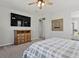 Comfortable bedroom with a ceiling fan, natural light, a decorative mirror, and neutral carpet at 904 Sundown Way, Erie, CO 80516