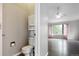 Half-bathroom next to an open entryway that leads to a bedroom with great natural lighting at 19135 E Hickock Dr, Parker, CO 80134