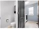This bathroom has tile flooring, grey cabinets, and a toilet at 19135 E Hickock Dr, Parker, CO 80134