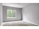 Bright bedroom with a large window that lets in natural light and neutral carpeting at 19135 E Hickock Dr, Parker, CO 80134