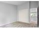 A bedroom with neutral carpeting and sliding closet doors next to an open doorway at 19135 E Hickock Dr, Parker, CO 80134