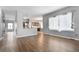 Open-concept dining room featuring hardwood floors, large window, modern light fixtures, and access to the kitchen at 19135 E Hickock Dr, Parker, CO 80134