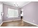 Dining room with a large window and contemporary chandelier at 19135 E Hickock Dr, Parker, CO 80134