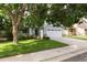 Charming two-story home with a manicured lawn, mature trees, and a two-car garage on a sunny day at 19135 E Hickock Dr, Parker, CO 80134