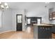 Open concept kitchen with bar seating looking into the fireplace room at 19135 E Hickock Dr, Parker, CO 80134