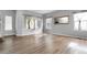 Bright living room with hardwood floors, large windows, neutral walls, and a large decorative mirror at 19135 E Hickock Dr, Parker, CO 80134