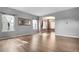 Spacious living room with light gray walls, wood floors, large windows, and elegant archway leading to dining area at 19135 E Hickock Dr, Parker, CO 80134