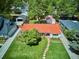 Charming home with a red tile roof, lush lawn, mature tree, and a stone walkway at 225 N Ivanhoe St, Denver, CO 80220