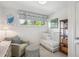 Bright Bedroom with a white crib, comfy chair, and natural light streaming through the window at 225 N Ivanhoe St, Denver, CO 80220