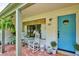 Inviting front porch with white rocking chairs, blue door, and potted plants at 225 N Ivanhoe St, Denver, CO 80220