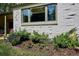 Charming home with a well-manicured front yard, featuring a beautiful flower bed and mature landscaping at 225 N Ivanhoe St, Denver, CO 80220