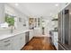 Modern white kitchen featuring stainless steel appliances, sleek countertops, and hardwood floors at 225 N Ivanhoe St, Denver, CO 80220