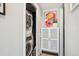 Efficient laundry closet with stacked washer and dryer, next to a storage cabinet with artistic decor at 225 N Ivanhoe St, Denver, CO 80220