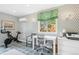 Well-lit office with stylish wallpaper, a functional desk setup and exercise bike at 225 N Ivanhoe St, Denver, CO 80220